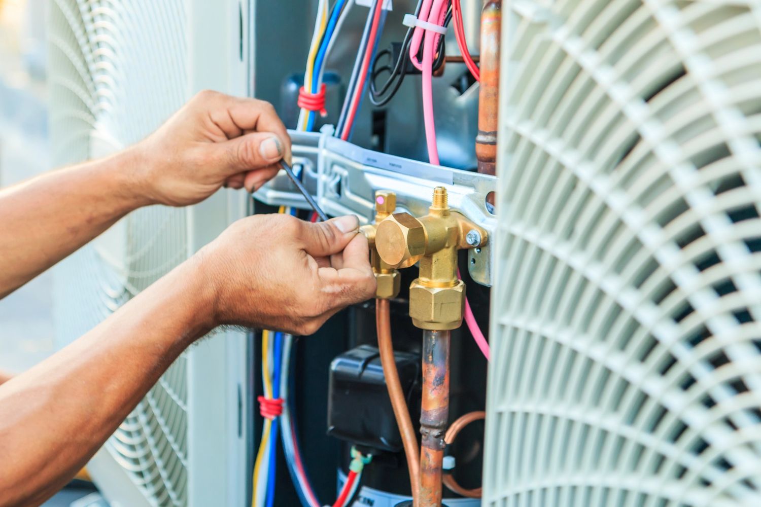 Technician fixing AC unit with tools, providing free estimate AC repair Katy TX services.