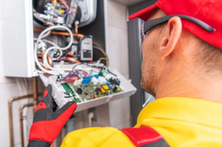 Licensed technician servicing outdoor electrical panel for HVAC system by best AC repair company in Katy TX.
