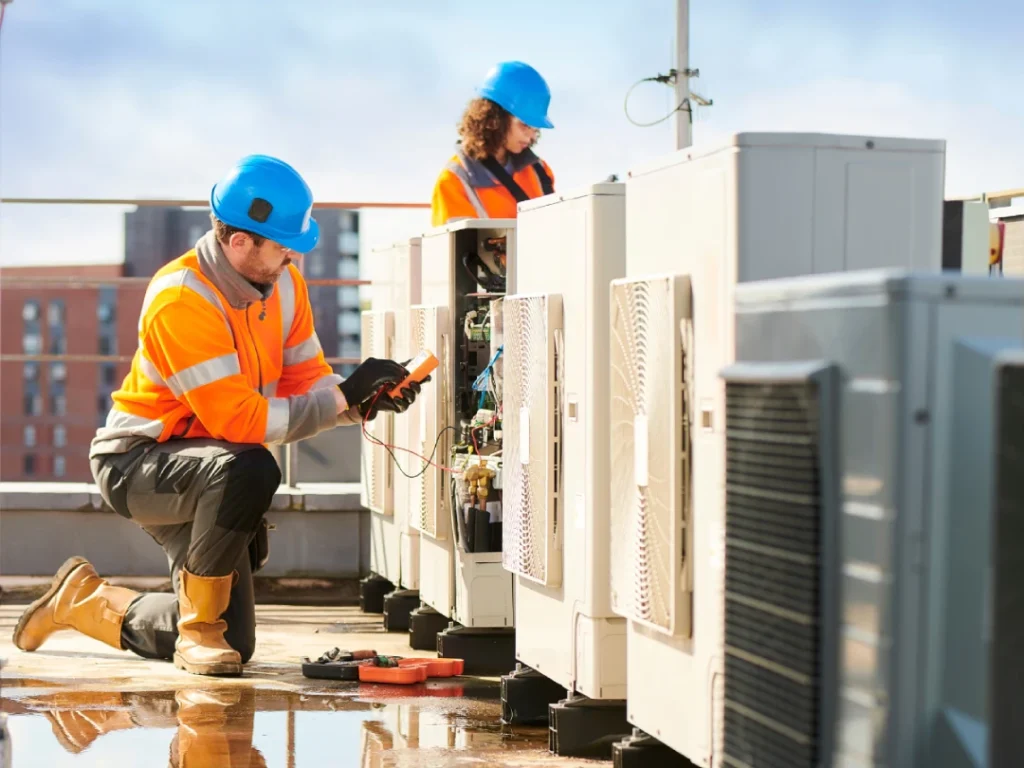 HVAC technicians servicing rooftop AC units for free quote AC repair in Katy, TX.
