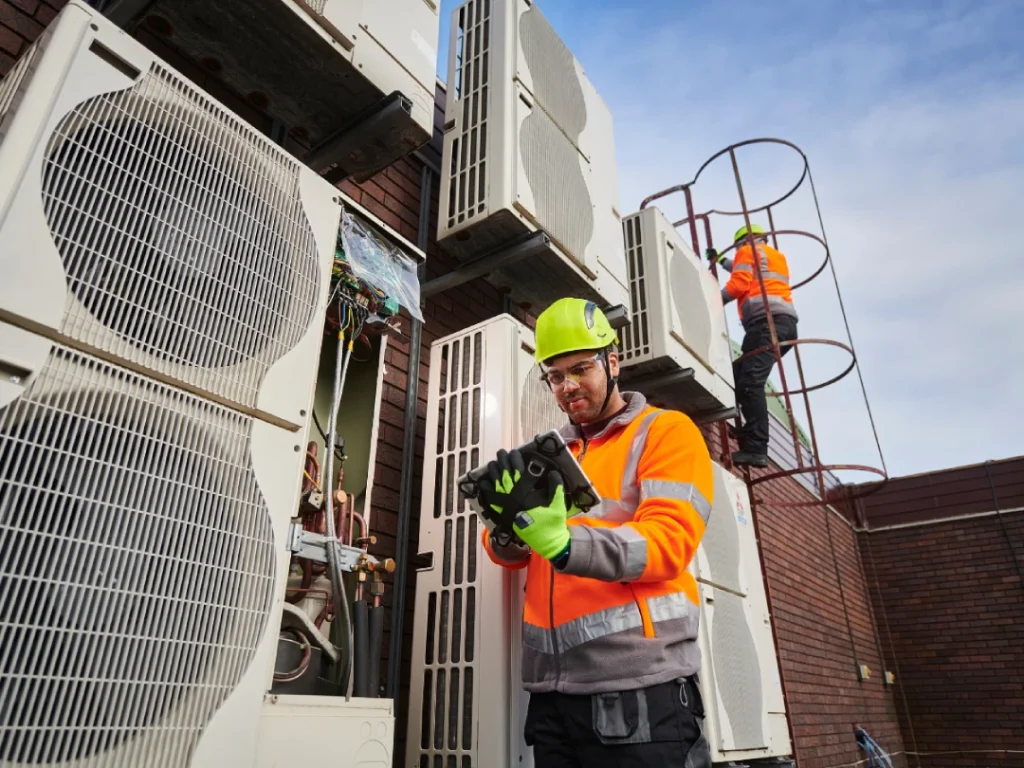 HVAC technicians installing rooftop AC units for top-rated HVAC repair in Katy, TX.