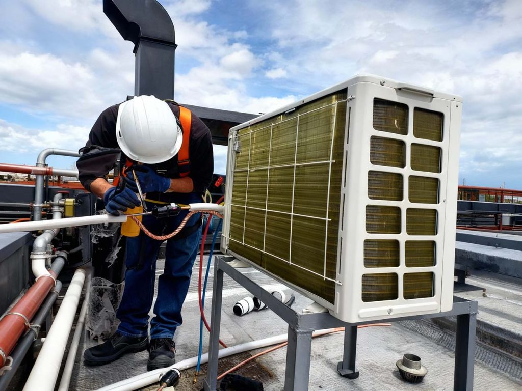 Technician on rooftop delivering same day AC repair Katy TX – fast emergency response