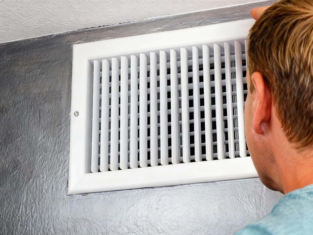 Emergency air conditioner service Katy Texas checking refrigerant levels on an outdoor condenser.