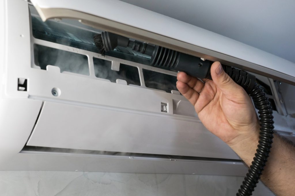 Reliable AC Not Cooling Repair Katy TX expert inspecting internal filters to improve home airflow and efficiency.