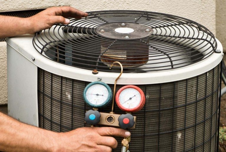 Experienced HVAC technician checking rusty outdoor AC condenser with clipboard for reliable AC repair with financing in Katy TX