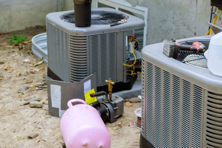 Professional setup with open condensers and refrigerant recharge during service by the best AC repair company in Katy TX for peak efficiency.