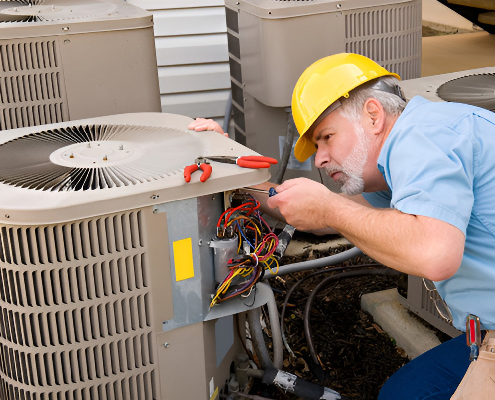 Experienced HVAC technician repairing an outdoor dual fuel HVAC system Katy TX homeowners rely on for efficient heating