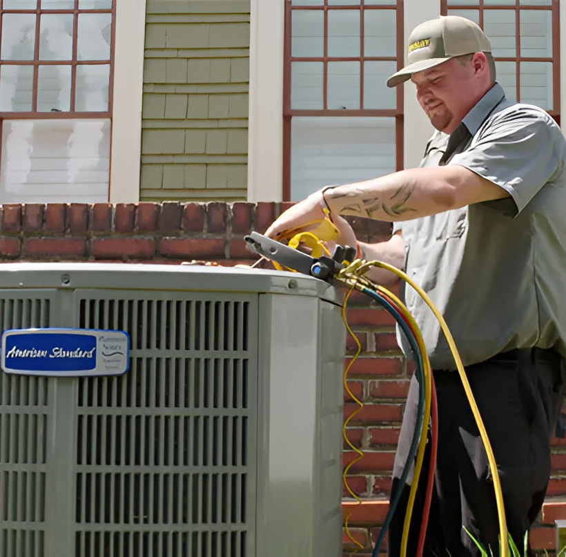 HVAC technician servicing an outdoor residential dual fuel HVAC system Katy TX homeowners rely on for comfort