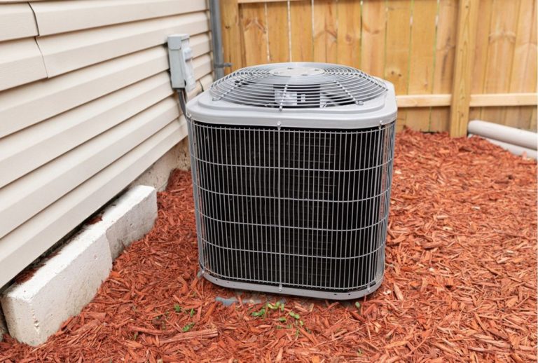 Outdoor air conditioning condenser unit situated on a concrete pad next to a house, indicating a home needing duct replacement Katy TX.