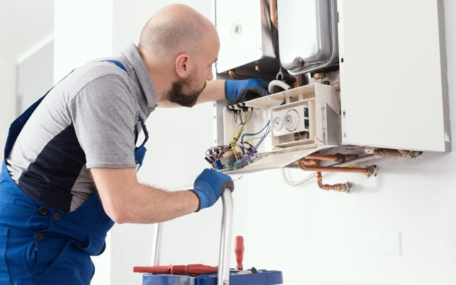 Expert hvac team member performing a precise ac installation fulshear tx by inspecting internal system components.