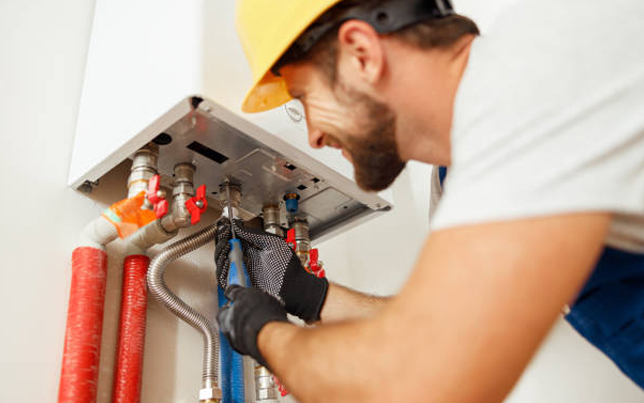 Certified pro finalizing a residential ac installation fulshear tx by connecting pipes to an indoor heating unit.