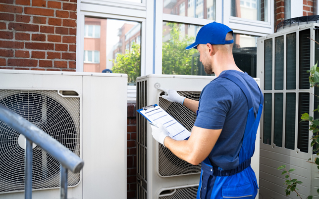 Reliable specialist verifying details for an ac installation fulshear tx while checking multiple exterior units.