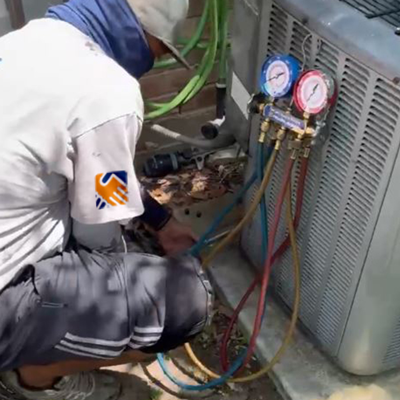 Local technician providing an ac maintenance fulshear tx by examining the electrical wiring on an outdoor unit.