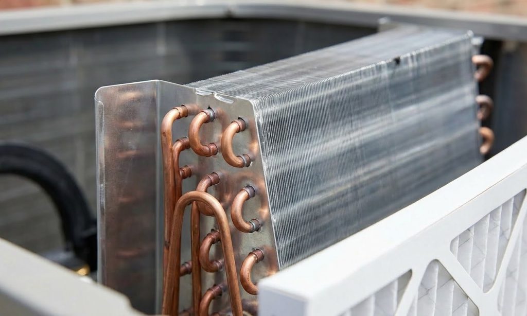 Close-up of pristine, clean condenser coils and a new filter after expert AC maintenance Katy Tx service, ensuring efficiency.