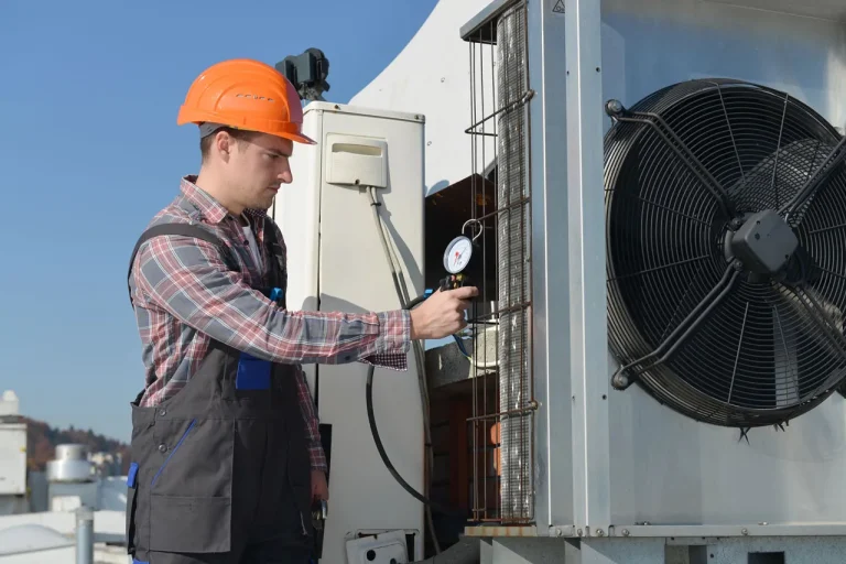 Technician performs a refrigerant pressure check on a rooftop unit for a free quote AC repair Katy TX service call.
