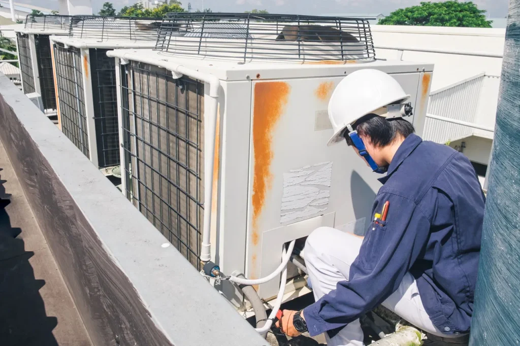 Providing a free quote AC repair Katy TX for commercial HVAC maintenance on a row of industrial rooftop cooling units.