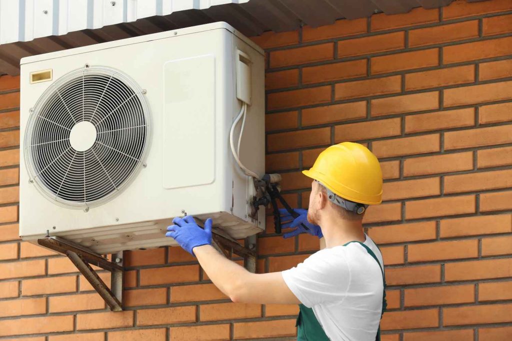 Expert technician offering affordable AC repair Katy TX homeowners trust during a routine HVAC maintenance check. 