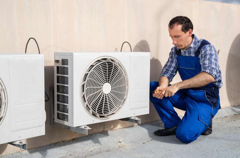 Skilled HVAC specialist fixing a rooftop mini split system, delivering affordable AC repair Katy TX can rely on.