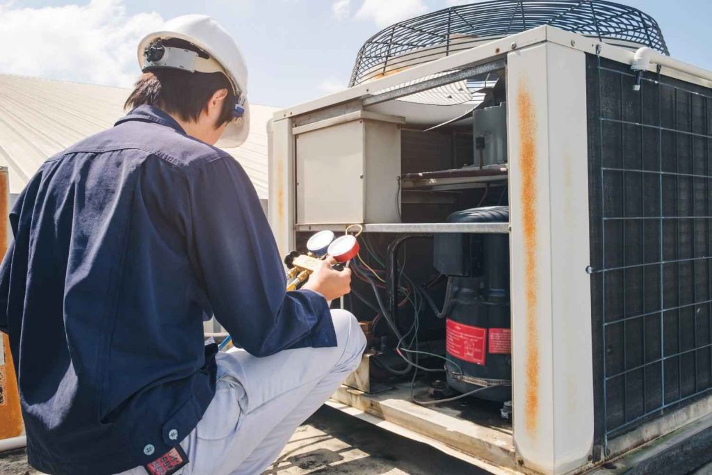 Technician checking a commercial unit to provide a free quote AC repair Katy TX homeowners and businesses trust.