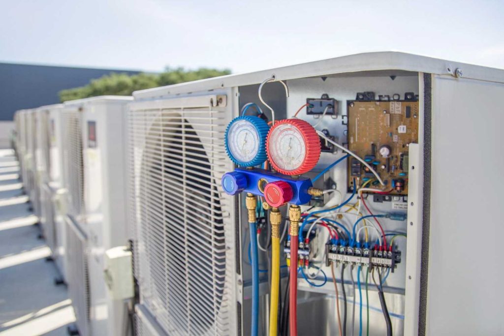 HVAC manifold gauges hooked up to a cooling system during a diagnostic for a free quote AC repair Katy TX service. 