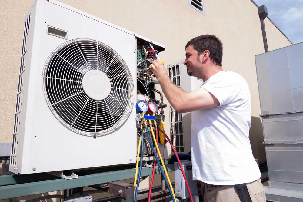 Commercial technician troubleshooting a rooftop system using local AC service Katy TX repair solutions.