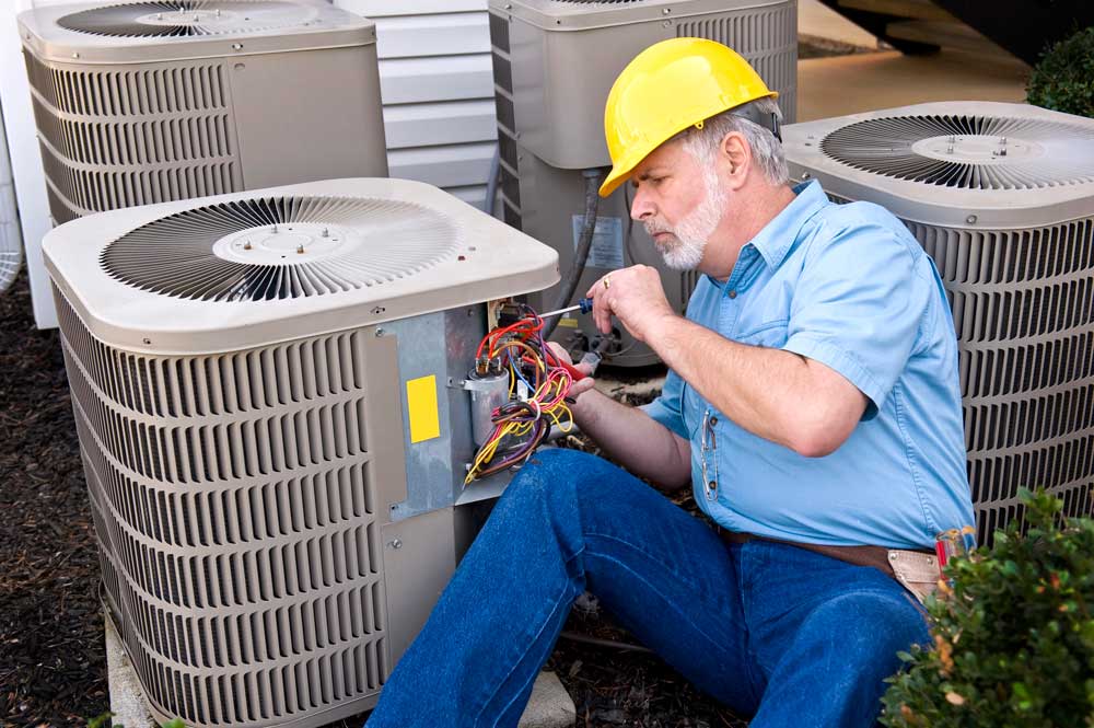 Residential technician providing local AC service Katy TX during outdoor unit capacitor maintenance.